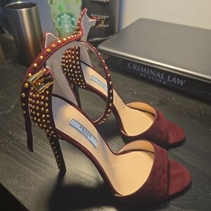 prada purple suede heels with gold accents